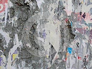 Fragment of old wall texture with traces of many layers of torn posters and announcements