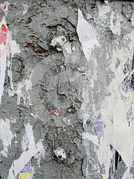 Fragment of old wall texture with traces of many layers of torn posters and announcements