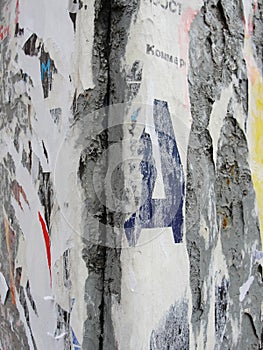 Fragment of old wall texture with traces of many layers of torn posters and announcements