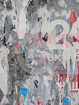 Fragment of old wall texture with traces of many layers of torn posters and announcements
