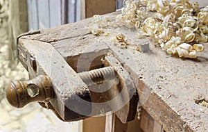 Fragment of old woodworking workbench with fixing devices of workpieces photo
