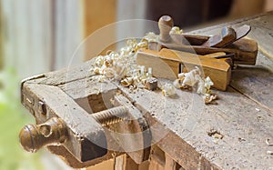 Fragment of old woodworking workbench with two wooden hand plane