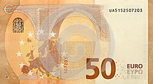 Fragment of one fifty euro money bill. Details of European union currency banknote of 50 euro