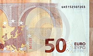 Fragment of one fifty euro money bill. Details of European union currency banknote of 50 euro