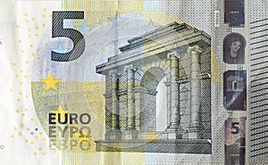 Fragment of one five euro money bill. Colorful details of European union currency banknote of five euro