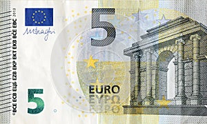 Fragment of one five euro money bill. Colorful details of European union currency banknote of five euro