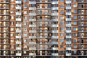 Fragment of one of the serial high-rise apartment buildings in Moscow suburbs with the sunset glare on the wall and