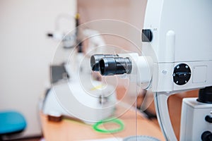 Fragment of ophthalmic laser system in eye surgery clinic. Selective focus, close up. photo