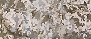 Fragment of pants of digital camouflage fabric with different pockets photo