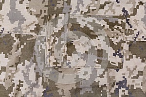 Fragment of pants of pixellated digital camouflage fabric with pocket photo