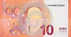 Fragment part of 10 euro banknote close-up with small red details