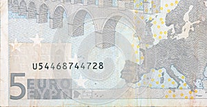 Fragment part of 5 euro banknote close-up with small brown details
