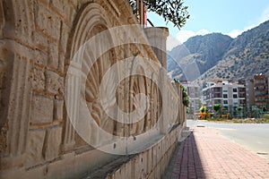 A fragment of patterned stone wall in sunny summer day