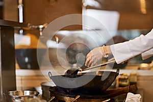 Fragment photo of delicious dish being prepared in a wok