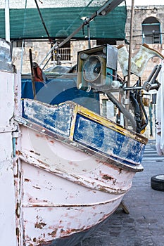 Fragment of the pink side of an old Maltese boat with a motor.