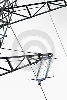 A fragment of a power line on a light background. Concept: transmission of electricity, power grids and electrical substations.