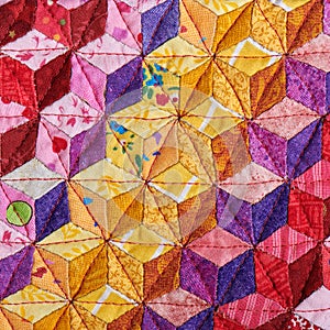 Fragment of quilt sewn from diamonds and has view three-dimensional