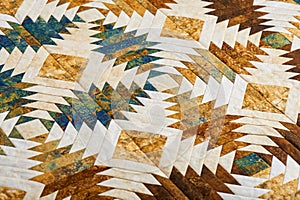 Fragment of quilt stitched from pineapple pattern blocks