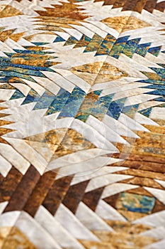 Fragment of quilt stitched from pineapple pattern blocks