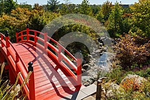 Fragment of the red bridge in Japanese garden of public landscape park of Krasnodar or Galitsky park,