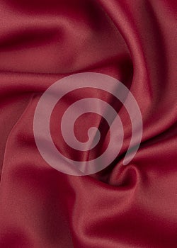 A fragment of a red curtain in folds