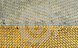 Fragment of a road and sidewalk with a paving stone. European pavement texture