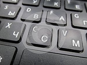 Fragment of a Russian-English laptop keyboard, an image with a shallow depth of field