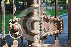 Fragment of rust-covered metal gates with a lock