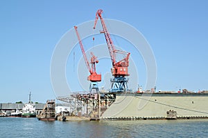 Fragment of ship dock with port cranes. City Svetlyj, Kaliningrad region