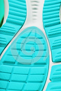 Fragment of the sole of a blue sneaker close-up. Textured texture of the material of sports shoes