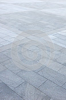 Fragment of the square paved of a large granite tiles