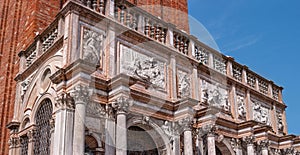 Fragment of St Mark`s Campanile - famous bell tower of St Mark`s Basilica and Loggetta. Piazza San Marco, Venice, Italy