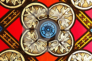 A fragment of stained glass. Fragment of colored ornamental glass of window of the church.