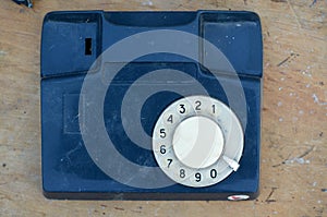 Fragment of stationary phone on a wood background