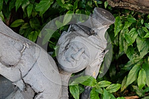 A fragment of a stone statue depicting the embittered face of a man