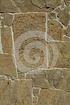Fragment of the stone wall with a flat brown pattern