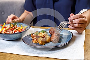 A fragment of the table setting in a restaurant or cafe. Salad, first and second course.