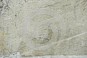 Fragment of texture of concrete wall of building with old cracked plaster with damp moldy cracks. Abstract background. Empty space