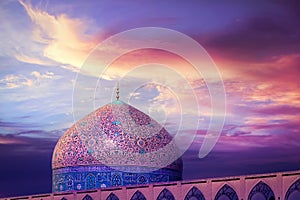 Fragment of traditional Iranian architecture against beatiful purple sky and yellow and pink clouds. Beautiful sunset.