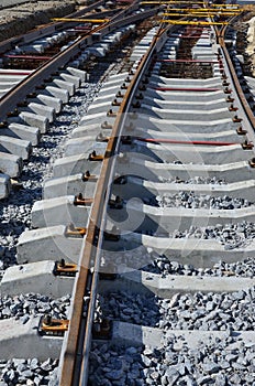 Fragment of tram rails at the stage of their installation and integration into the road. The process of laying a tramwa