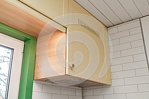 Modern kitchen design with yellow cabinets and wooden knobs