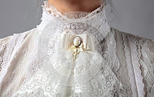 Fragment of a Victorian dress with a brooch
