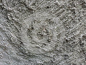 Fragment of wall covered with rough decorative plaster, outdoors