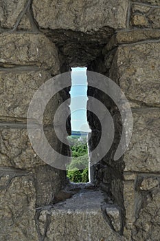 Embrasure in the wall of fortress photo