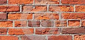 A fragment of a wall made of old red bricks, a conceptual background