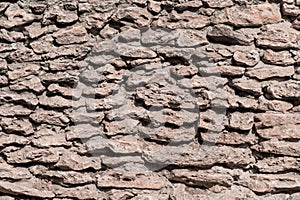 A fragment of a wall made from rough stone