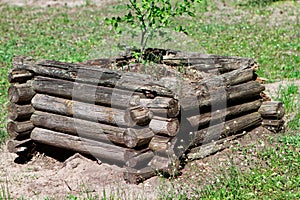 Fragment of the wall of the old ruined wooden house of logs