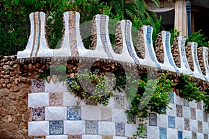 Fragment of a wall in the park of Guell Antonio Gaudi with flowering bushes. Barcelona photo