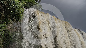 A fragment of a waterfall. Close-up. Seething, foaming streams of water