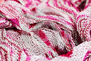 Fragment of white and pink colored fabric texture scarf. Best use as background